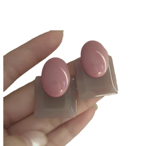 Vintage oval geometric earrings with pink and taupe resin contrast on a white background