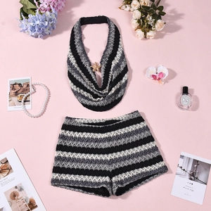 Detail of crochet knit two-piece set featuring wave pattern with elegant accessories