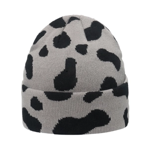 Winter knitted beanie featuring grey and black cow print pattern with wide folded cuff