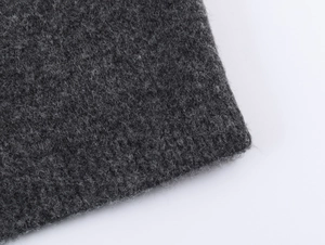 Macro detail of dark grey knit fabric with soft fiber texture and thick wool-like feel