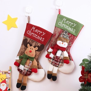 Hanging Christmas stockings with reindeer and snowman patterns for festive holiday decor