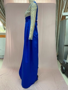 Detail of blue evening dress featuring silver floral embroidery and beaded bodice