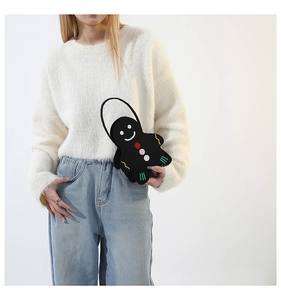 Close-up of a gingerbread man shaped felt handbag with smile and button detail