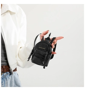 Close-up of mini black faux leather coin purse with zipper and metal hook attachment