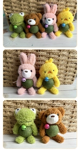 Detail of plush catnip ball toys showing frog, bear, rabbit and chick with bell