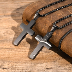 Detail of black stainless steel cross necklaces with silver crackle pattern and small stone