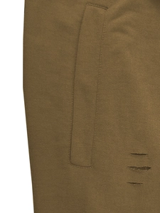 Macro detail of brown knitted shorts showing fabric texture and parallel distressed cuts