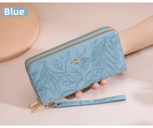 Detailed view of blue leaf embossed long wallet with double zipper and wrist strap
