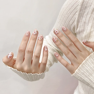 Hand-painted 3D cherry blossom press-on nails with pearls in nude pink oval shape