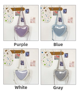 Detail of four colors of heart-shaped Itabags with clear PVC windows and straps