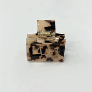 Close-up of a large tortoiseshell hair claw clip with a classic rectangular hollow design