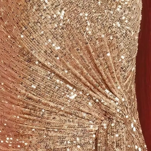 Detail of rose gold sequins fabric with elegant pleated texture for evening gown