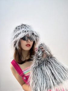 Close-up of grey long-hair faux fur bucket hat and matching plush handbag textures