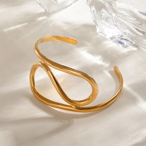 Minimalist gold stainless steel open bangle with twisted wavy lines and polished finish