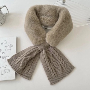 Detail of beige faux fur collar with cable knit texture on a cozy winter scarf