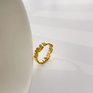 Detail of a hollow butterfly pattern ring in a high-polished golden finish finish