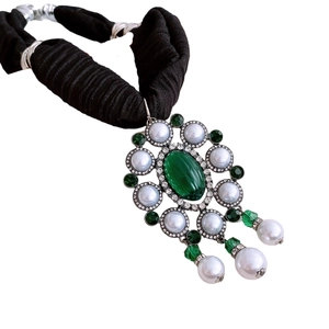 Vintage necklace with emerald green pendant and pearls on a black woven fabric strap