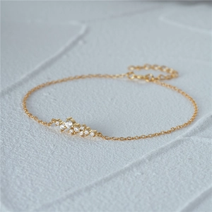 Detail view of a 925 sterling silver gold bracelet with multiple white round zircons
