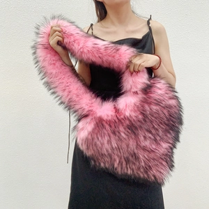 Detail of heart-shaped faux fur bag featuring pink and black gradient plush textures