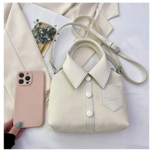 Detail of creative cream white shirt-shaped tote bag with buttons and fashion text