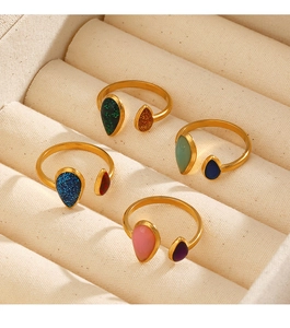 Detail view of colorful enamel water drop open rings in a velvet jewelry box