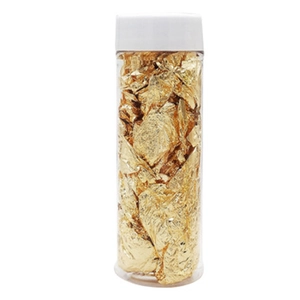 Edible gold leaf flakes in a clear jar for decorative birthday cake and pastry DIY baking