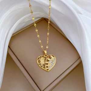 Luxurious gold hollow heart necklace featuring clear crystals and a vintage embossed figure