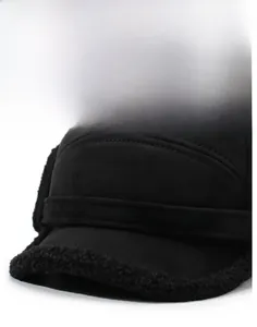 Detail of winter trapper hat featuring a stiff brim and soft fleece lining for cold weather