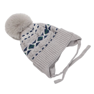 Close-up of geometric jacquard knit pattern and soft pompom on boys earflap hat