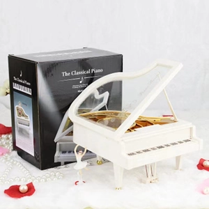 White piano music box with rotating ballerina figure and elegant black gift packaging