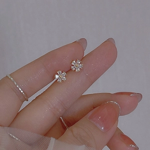 Mini flower stud earrings with 925 silver needles and zircon petals held in hand