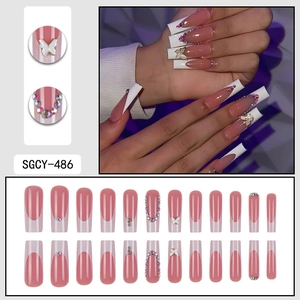 Pink and white French tip press-on nails with 3D butterfly and rhinestone accents