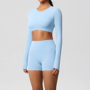Detail of light blue long sleeve yoga top and high waist shorts set on model