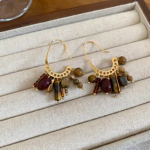 18k gold plated vintage tassel earrings with red and tiger eye stone beads on velvet