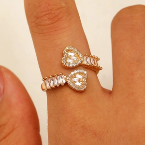 Detailed view of double heart open ring with baguette and round cut crystals
