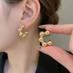 Polished 18K gold-plated C-shaped bead earrings in a minimalist metal sphere design