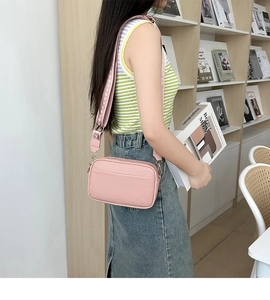 Pink lychee texture crossbody camera bag shown with a stylish wide geometric strap