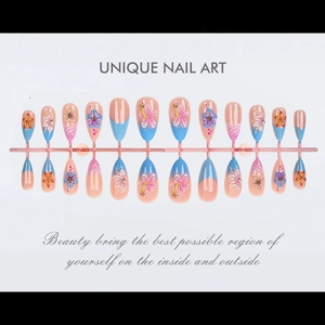 Macro view of 3D embossed almond false nails with pink blue gradient and floral patterns