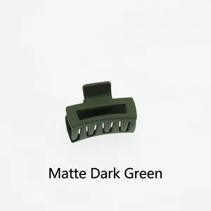 Detail view of the matte dark green hollow rectangular hair claw clip with multi-tooth grip