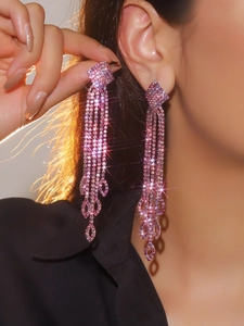 Detail of luxury pink rhinestone tassel earrings with shimmering crystals and droplets