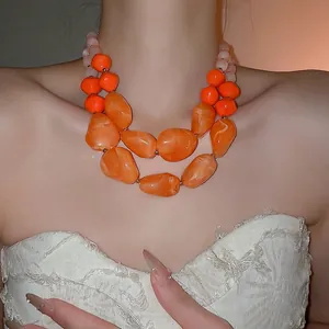 Double-layered acrylic necklace with irregular orange beads and pink pearls for women