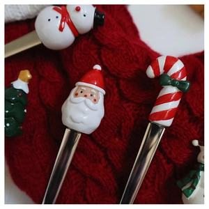 Gros plan de couteaux à beurre de Noël avec manches en résine Père Noël sur tricot