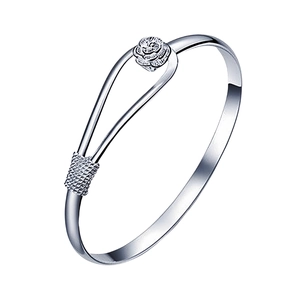 Detailed view of silver rose bangle with 3D floral carving and textured accents