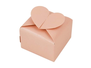Close-up of pink pearlescent paper gift box with creative heart-shaped closure detail
