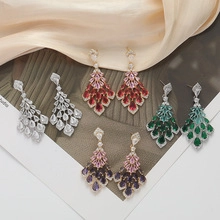 Detailed view of cascading teardrop rhinestone tassel earrings in multiple colors