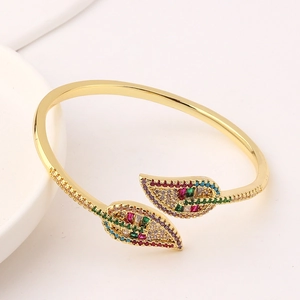Gold plated leaf shape open bangle with colorful zircon stones in diagonal view