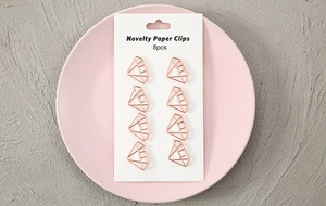 Detail view of 8 diamond-shaped golden novelty paper clips on a white display card