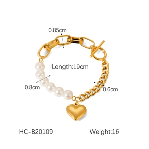 Detailed view of heart pendant pearl bracelet with golden chain and OT buckle closure