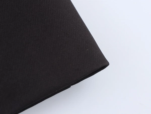 Detailed macro view of black woven textile fabric showing high-quality texture and pattern