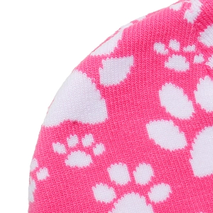 Macro shot of pink and white knitted fabric texture with cute animal paw print patterns
